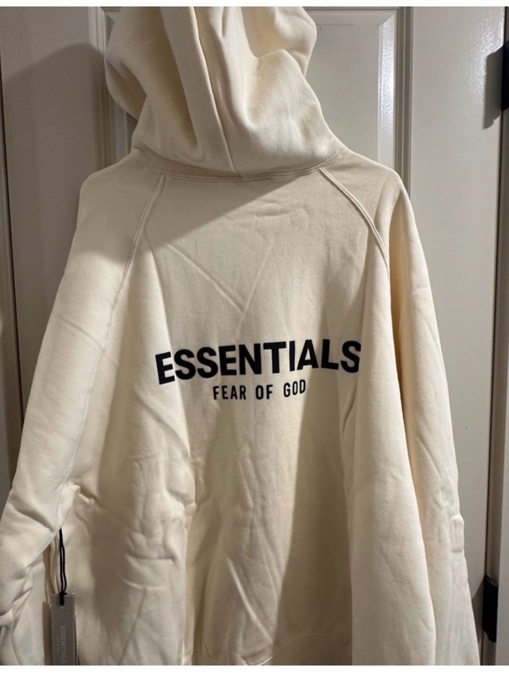 Fear of God ESSENTIALS Hoodie in Cream with Black Logo